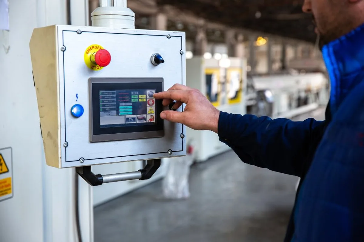 Operator programming a CNC machine at the Kay Switchgears works